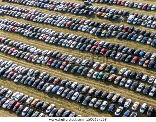 Outdoor\
parking, lots of cars in the field. Top\
view