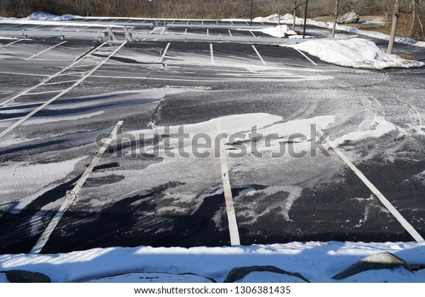 outdoor parking lot with snow removed and sprayed salt  \
      