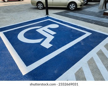 Outdoor parking space for people with disabilities, fairness and equality concept.