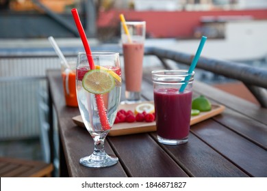 An Outdoor Patio Bar Top With A Fruit Platter, And Glass Drinks With Food-grade, Silicone Straws Which Are Reusable And A Plastic-alternative That Is More Sustainable