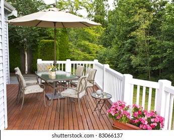 Outdoor Patio Setup On Cedar Wood Deck  With Trees In Background