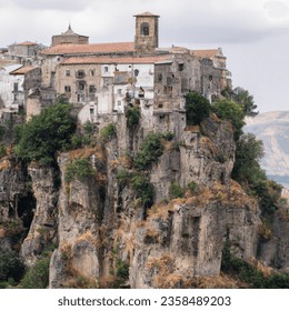 Outdoor photo of city build into cliff panoramic medieval