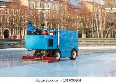 Outdoor Photo Of Special Machine Leveling Ice Rink In Motion, Side View/ Ice Maintenance Machine Clean And Pours Ice Before The Game, Ice Resurfacer At Work, Public Skating Rink, Hockey Stadium.