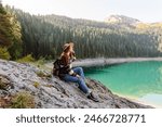 Outdoor picture of woman having vacation,  posing near forest and mountains, casual outfit. Active life. Lifestyle, travel, tourism