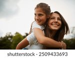 Outdoor, piggyback and sister with smile, child and bonding in nature, thinking and happy in forest. Love, girls and fun in woods, carrying and teenager with care for kid, siblings and contemplating