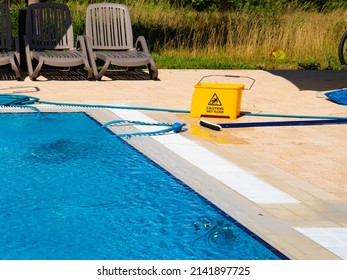 Outdoor Pool Cleaning Equipment. Caution Wet Floor Sign.  Concept Photo  Pool Cleaning, Hotel Staff, Service.