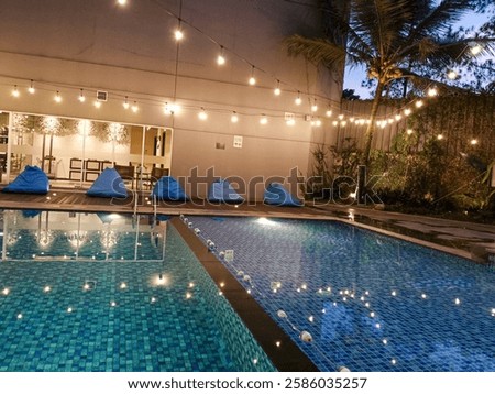 Outdoor Pool At Night With String Lights And Seating For Relaxation