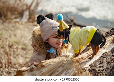 Outdoor Portrait Of 10- 11 Year Old Girl Wearing Warm Beige Jacket With A Chihuahua Dog. Birthday