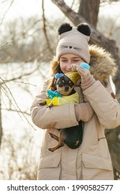 Outdoor Portrait Of 10- 11 Year Old Girl Wearing Warm Beige Jacket With A Chihuahua Dog. Birthday