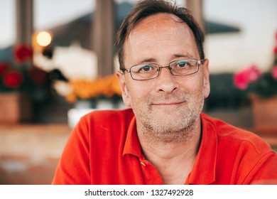 Outdoor Portrait Of 50 Year Old Man Wearing Red Polo Shirt And Eyeglasses