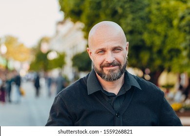 Outdoor Portrait Of A 50 Year Old Happy Man Wearing A Black Shirt 