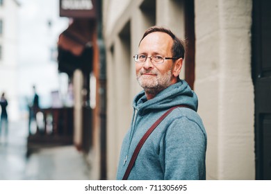 Outdoor Portrait Of 50 Year Old Man Wearing Blue Hoody And Eyeglasses