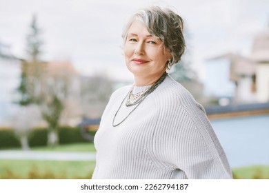 Outdoor portrait of beautiful 55 - 60 year old woman  - Shutterstock ID 2262794187