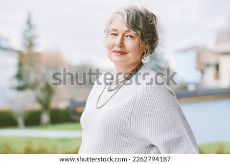 Outdoor portrait of beautiful 55 - 60 year old woman 