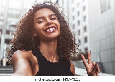 Outdoor Portrait Beautiful Happy Afroamerican Woman Taking Selfie Photograph Smiling Laughing With Perfect Teeth At Street.