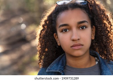 Outdoor Portrait Of Beautiful Happy Mixed Race African American Girl Teenager Female Child Looking Thoughtful Or Sad