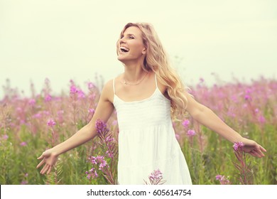 outdoor portrait of a beautiful middle aged blonde woman. attractive sexy girl in a field with flowers