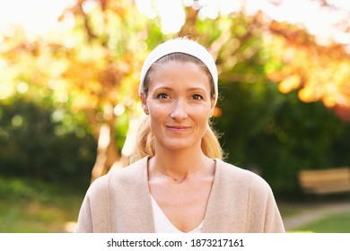 Outdoor portrait of beautiful woman in sunny park