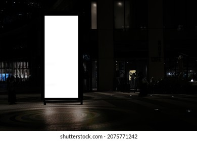 Outdoor Portrait Blank Digital Signage Light Box Mock Up Near Retail Stores And Restaurants Taken At Night, Ideal For Large Posters, Huge Information Boards, And Marketing Advertisement