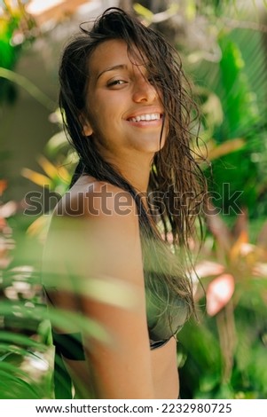 Similar – Brunette surfer woman with top and bikini holding surfboard