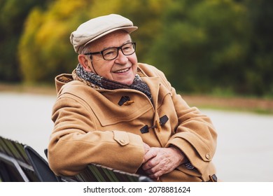 Outdoor Portrait Of Cheerful Senior Man In Winter Coat.