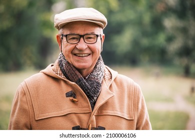 Outdoor Portrait Of Cheerful Senior Man In Winter Coat.