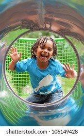 Outdoor Portrait Of A Cute African American Little Boy Playing At Playground