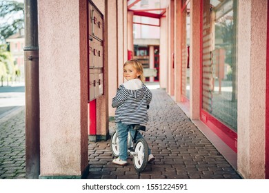 Outdoor Portrait Of Cute Kid Girl Riding Bike In Neighborhood, Checking Mailbox