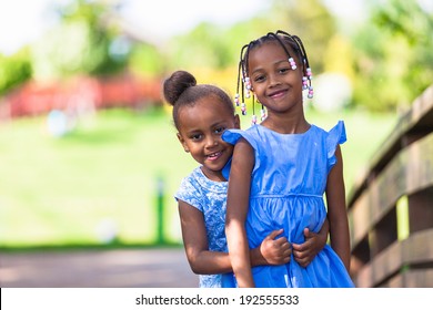 Outdoor  Portrait Of A Cute Young Black Sisters Smiling - African People - African People