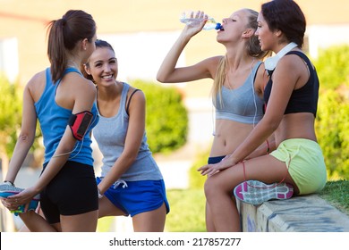 Outdoor Portrait Of Group Of Young Women Doing Stretching In The Park.