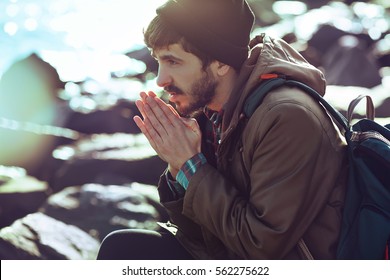 Outdoor Portrait Of A Handsome Brutal Bearded Man With Dark Beard And Mustache Dressed In Winter Clothes,covered With Frost. Man Wear Coat And Grey Hat.hipster Man Style
