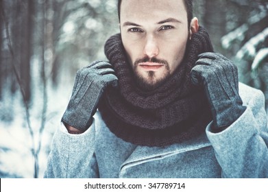 Outdoor Portrait Of Handsome Man In Coat And Scurf. Casual Winter Fashion