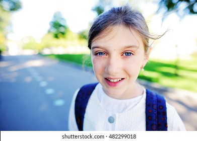 Outdoor Portrait Of Happy Girl 10-11 Year Old With Backpack. Back To School Concept.