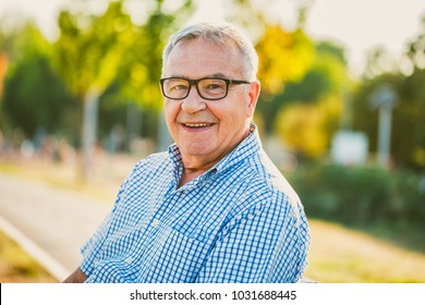 Outdoor portrait of happy senior man. 
