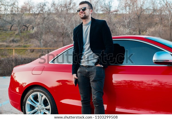 Outdoor portrait\
man with a smart phone. bearded happy businessman looking, man in\
jacket, driver, hipster in sunglasses, mechanic, attractive,\
pretty, model, hand watch, man near\
car