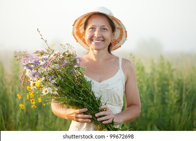 Outdoor Portrait Of   Mature Woman With Flowers Posy