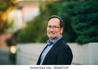 Outdoor Portrait Of Middle Age Man Wearing Suit And Glasses