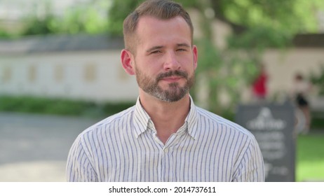 Outdoor Portrait of No Sign by Mature Adult Man by Head Shake 