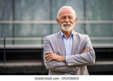 Outdoor portrait of senior businessman in front of company building. - Powered by Shutterstock