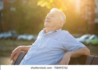 Outdoor Portrait Of Senior Man Who Is Enjoying Sun.