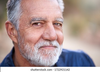 Outdoor Portrait Of Serious Hispanic Senior Man With Mental Health Concerns