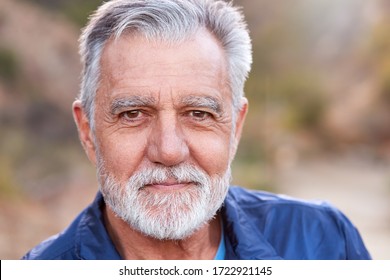 Outdoor Portrait Of Serious Hispanic Senior Man With Mental Health Concerns