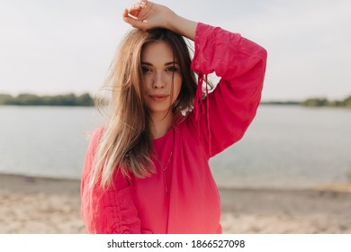  Outdoor portrait of stylish woman in pink outfit posing outdoor in summer day