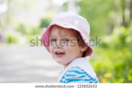 Similar – small girl wearing a hat singing happily