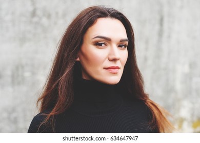 Outdoor Portrait Of Young 35 Year Old Woman With Long Dark Hair, Wearing Black Turtle Neck Dress