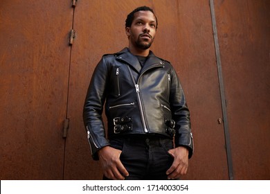 Outdoor Portrait Of Young African Man Wearing Biker Leather Jacket. Handsome And Confident. 