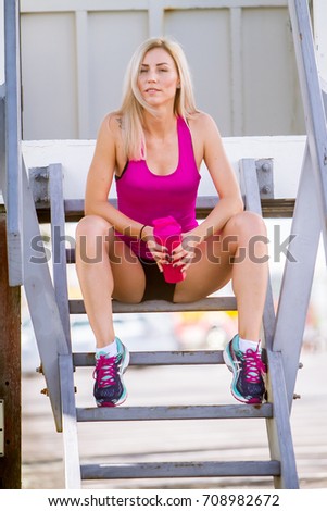 Similar – Young woman stretching arms before training outdoors