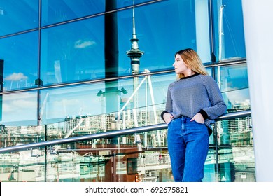 Outdoor Portrait Of Young Happy Smiling Teen Girl Enjoying Her Trip To Auckland, On City Scape Reflection Background