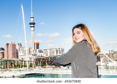 Outdoor Portrait Of Young Happy Smiling Teen Girl Enjoying Her Trip To Auckland, On City Scape Reflection Background