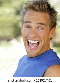 Outdoor Portrait Of A Young Man With Big Fun Expression Laughing